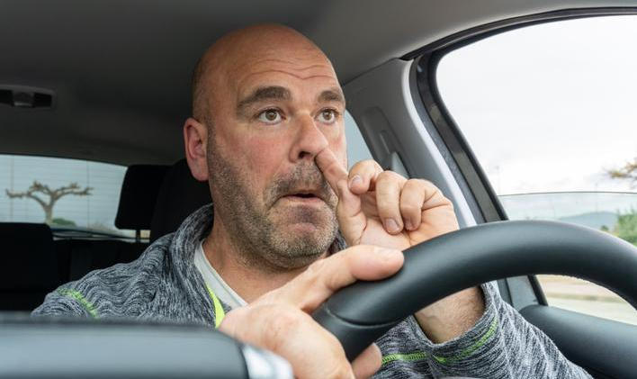 Middle,Aged,Man,Picking,His,Nose,Driving,A,Car.