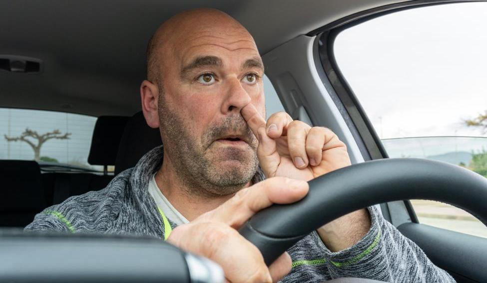 Middle,Aged,Man,Picking,His,Nose,Driving,A,Car.