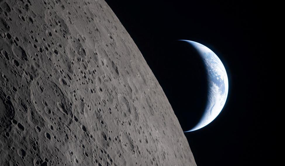 A view of Earth, partially hidden by the Moon, photographed through the Orion spacecraft window