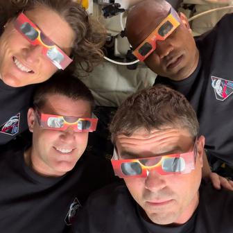 The Artemis II crew of NASA astronauts Christina Koch, Reid Wiseman, Victor Glover and Canadian Space Agency astronaut Jeremy Hansen pose with their eclipse glasses