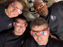 The Artemis II crew of NASA astronauts Christina Koch, Reid Wiseman, Victor Glover and Canadian Space Agency astronaut Jeremy Hansen pose with their eclipse glasses