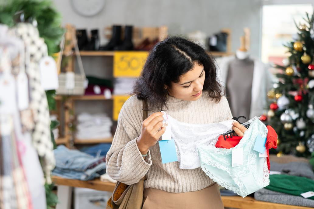 Female,Shopper,Selects,Panties,In,A,Fashionable,Clothing,Boutique