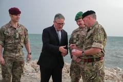 Britain's Prime Minister Keir Starmer meets military personnel on a beach in Bahrain
