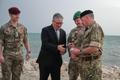 Britain's Prime Minister Keir Starmer meets military personnel on a beach in Bahrain