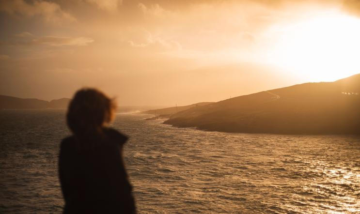 A,Back,View,Of,Human,Standing,And,Looking,To,Sea