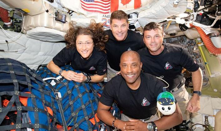 The NASA Artemis II crew pose for a photo