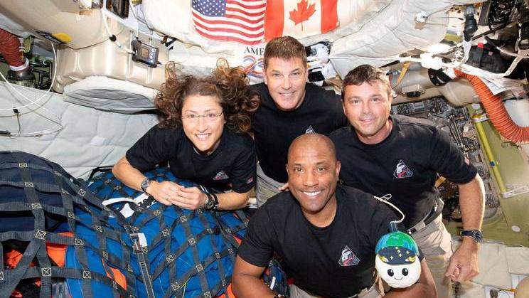 The NASA Artemis II crew pose for a photo