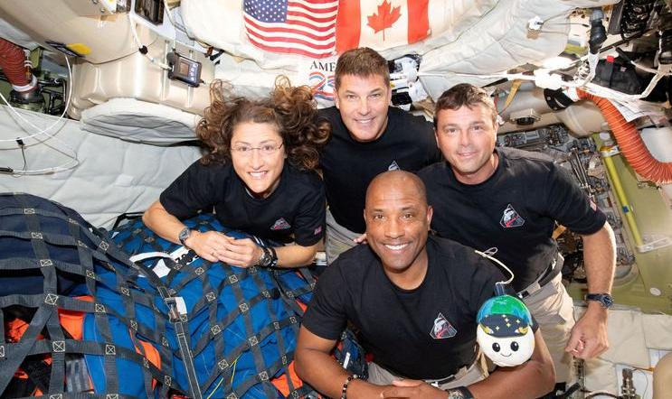 The NASA Artemis II crew pose for a photo