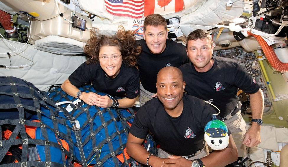 The NASA Artemis II crew pose for a photo