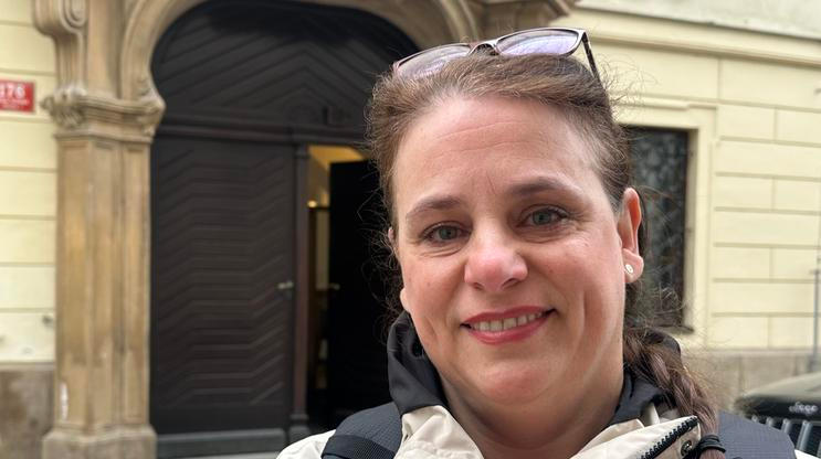 Paní Lucie stála 15. dubna 2026 ráno před Poslaneckou sněmovnou s transparentem proti vládě.