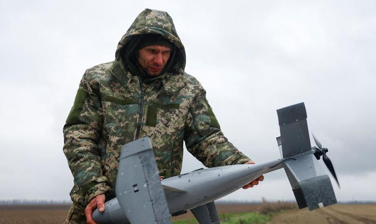 Ukrainian serviceman holds an interceptor drone, a part of MEROPS system, during a pre-flight checking at a training in an undisclosed location in Ukraine