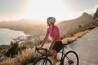 A,Female,Cyclist,Enjoying,A,Beautiful,Seaside,View,During,Sunset