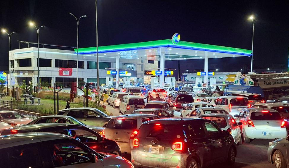 FILE PHOTO: Vehicles wait for their turn to get fuel at a petrol station, as Pakistan raises fuel prices amid the U.S.-Israeli conflict with Iran, in Islamabad