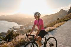 A,Female,Cyclist,Enjoying,A,Beautiful,Seaside,View,During,Sunset