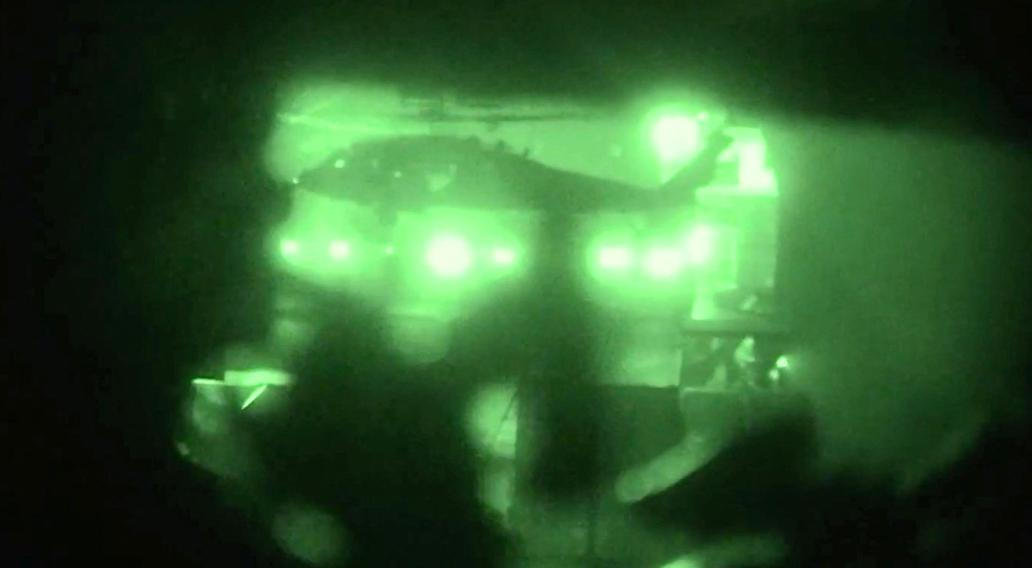 A helicopter carries U.S. Marines from the amphibious assault ship USS Tripoli at an unknown location