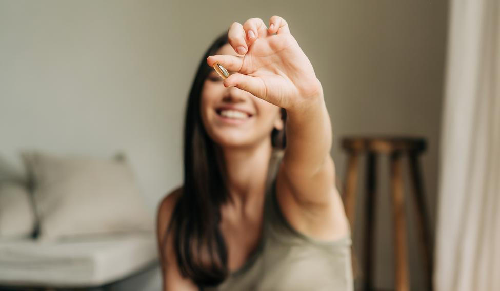 Happy,Healthy,Woman,Recommending,Omega,3,Fish,Oil,And,Holding
