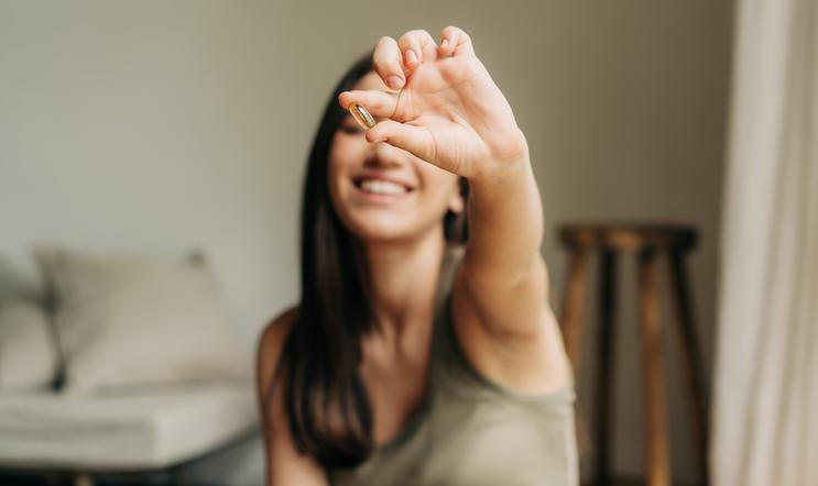 Happy,Healthy,Woman,Recommending,Omega,3,Fish,Oil,And,Holding