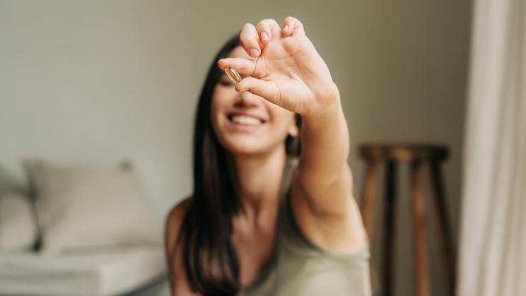 Happy,Healthy,Woman,Recommending,Omega,3,Fish,Oil,And,Holding