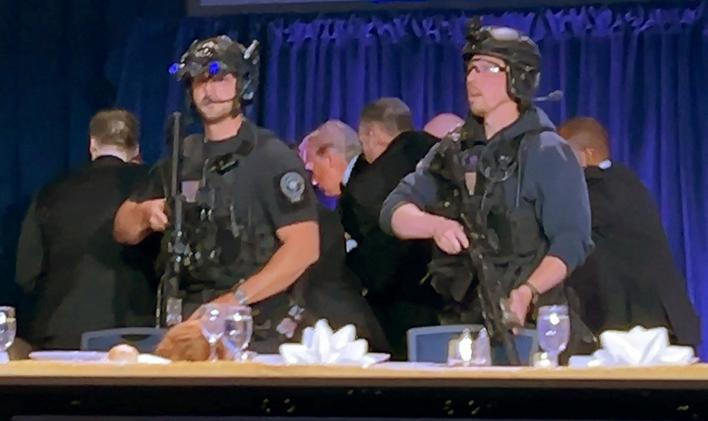 U.S. President Donald Trump is escorted out of the White House Correspondents' Association (WHCA) dinner in Washington