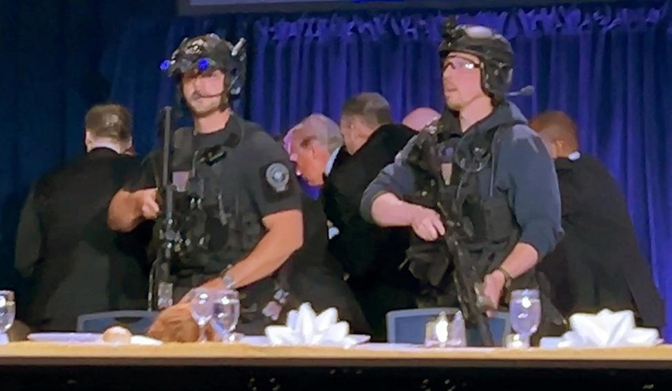 U.S. President Donald Trump is escorted out of the White House Correspondents' Association (WHCA) dinner in Washington