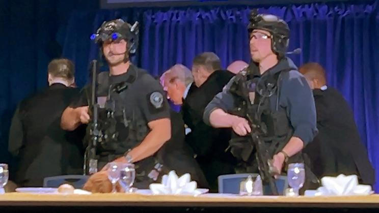 U.S. President Donald Trump is escorted out of the White House Correspondents' Association (WHCA) dinner in Washington