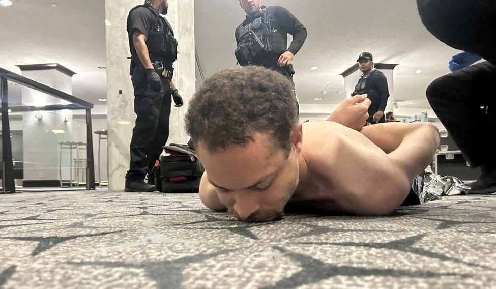 Law enforcement personnel detain Cole Tomas Allen, a suspect in the shooting incident at the White House Correspondents' Association dinner, in Washington