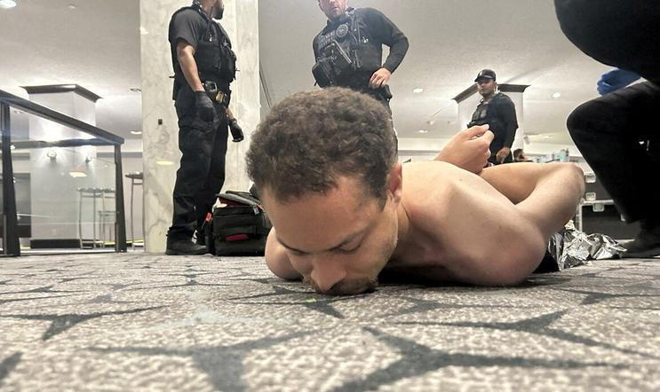 Law enforcement personnel detain Cole Tomas Allen, a suspect in the shooting incident at the White House Correspondents' Association dinner, in Washington