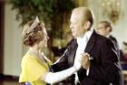 The queen, in a yellow dress, white gloves and tiara dancing with President Ford, in formal evening wear.
President Gerald R. Ford with Queen Elizabeth at a White House state dinner in 1976
