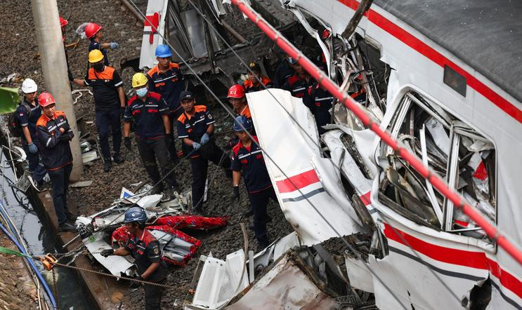 Aftermath of a deadly collision between a commuter line train and a long-distance train, in Bekasi