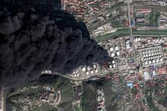 A satellite image shows smoke billowing, following drone attacks on a Russian oil facility in the Black Sea port of Tuapse