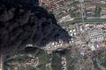 A satellite image shows smoke billowing, following drone attacks on a Russian oil facility in the Black Sea port of Tuapse