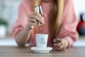 Close-up,Of,Woman,Hand,Throwing,Saccharin,Pills,On,Coffee,Cup