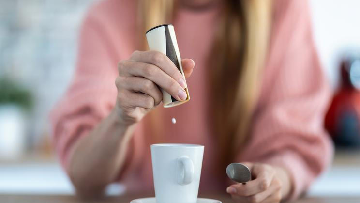 Close-up,Of,Woman,Hand,Throwing,Saccharin,Pills,On,Coffee,Cup