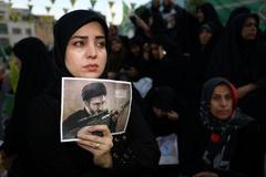 A woman holds a poster depicting Iran’s new Supreme Leader Mojtaba Khamenei, during a rally in Tehran