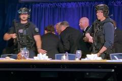 U.S. President Donald Trump is escorted out of the White House Correspondents' Association (WHCA) dinner in Washington