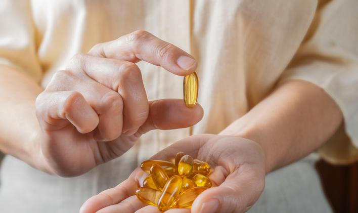 The,Woman,Holds,Omega-3,Capsules,In,Her,Hand