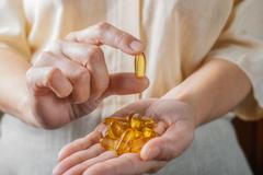 The,Woman,Holds,Omega-3,Capsules,In,Her,Hand