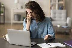 Tired,Frustrated,Freelance,Employee,Girl,Working,At,Laptop,,Taking,Eyeglasses