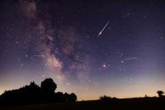 Milky,Way,Stars,With,Meteor,Shower,Trails,And,Countryside,Silhouettes.