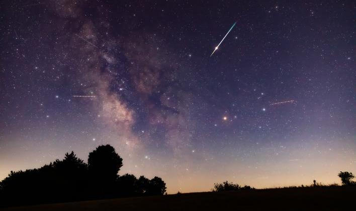 Milky,Way,Stars,With,Meteor,Shower,Trails,And,Countryside,Silhouettes.