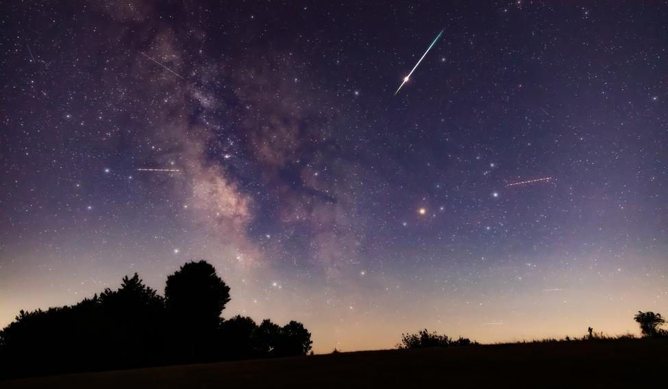 Milky,Way,Stars,With,Meteor,Shower,Trails,And,Countryside,Silhouettes.