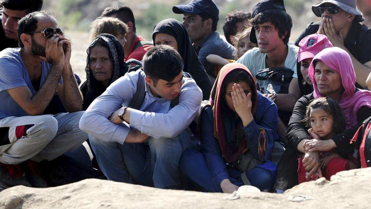 Migrants wait on the Greek side of the border to enter Macedonia near Gevgelija, Macedonia, en route to northern Europe
