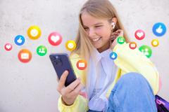 Teenage,Girl,Using,Social,Media,Apps,On,Mobile,Phone