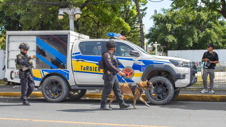 Tagbilaran,,Bohol,,Philippines,,07.27.2025,Police,Patrolling,Streets,With,Service,Dogs,