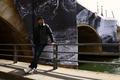 Artist JR poses in front of his art installation 'La Caverne du Pont-Neuf' in Paris 