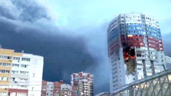 A plume of smoke rises next to a burning building, following a Ukrainian drone attack, in Ryazan