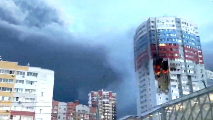 A plume of smoke rises next to a burning building, following a Ukrainian drone attack, in Ryazan