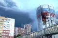 A plume of smoke rises next to a burning building, following a Ukrainian drone attack, in Ryazan