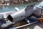 The wreckage of a drone is placed in a boat, at Hormuz Island