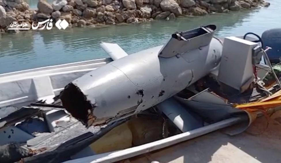 The wreckage of a drone is placed in a boat, at Hormuz Island